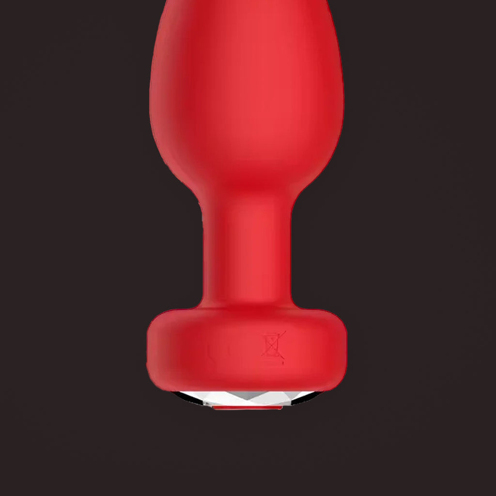Magpie, app-controlled vibrating jewel plug, close-up of the base and its jewel (Red)