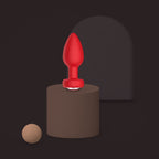 Magpie, app-controlled vibrating jewel plug, on a ceramic plinth (Red)