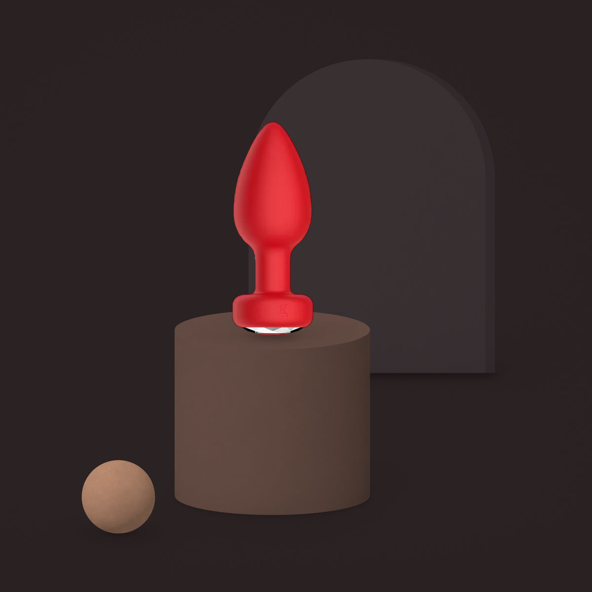 Magpie, app-controlled vibrating jewel plug, on a ceramic plinth (Red)