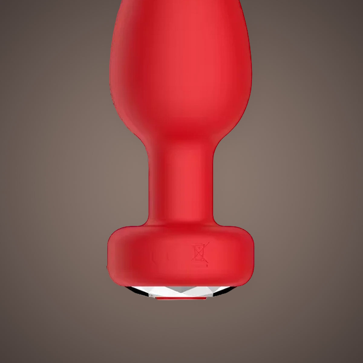 Magpie, app-controlled vibrating jewel plug, close-up of the base and its jewel (Red)